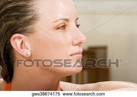 Close-up of a young woman looking sideways View Large Photo Image Stock Photography - Close-up of a young woman looking sideways. Fotosearch