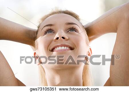 Close-up of a young woman looking up View Large Photo Image Stock Image - Close-up of a young woman looking up. Fotosearch