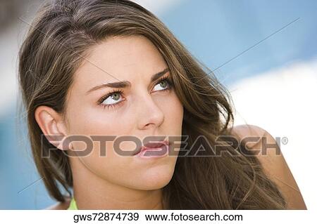 Stock Photo - Close-up of a young woman looking up. Fotosearch