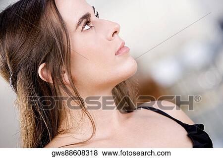 Close-up of a young woman looking up View Large Photo Image Stock Photo - Close-up of a young woman looking up. Fotosearch