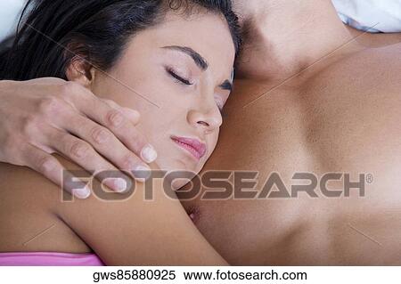 Close-up of a young woman lying with her head on a young man's chest View Large Photo Image Stock Photography - Close-up of a young woman lying with her head on a young man's chest. Fotosearch