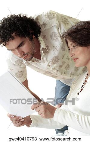 Close-up of a young woman showing documents to a young man View Large Photo Image Stock Image - Close-up of a young woman showing documents to a young man. Fotosearch