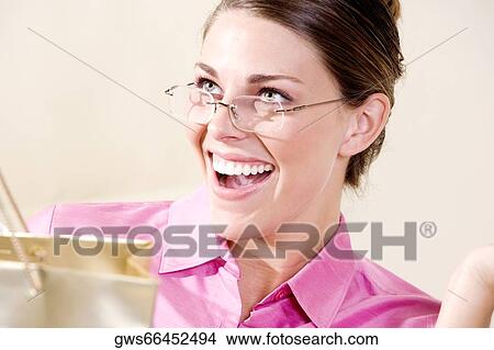 Close-up of a young woman smiling View Large Photo Image Picture - Close-up of a young woman smiling. Fotosearch