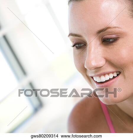 Close-up of a young woman smiling View Large Photo Image Picture - Close-up of a young woman smiling. Fotosearch