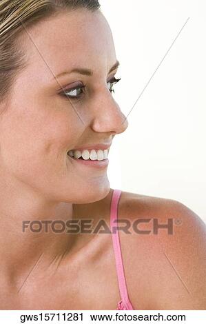 Close-up of a young woman smiling View Large Photo Image Stock Image - Close-up of a young woman smiling. Fotosearch