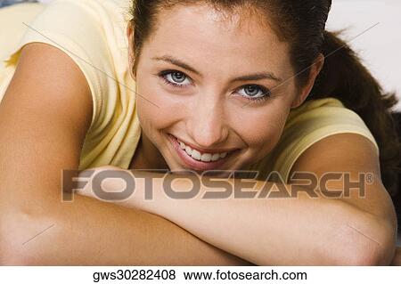 Close-up of a young woman smiling View Large Photo Image Stock Photo - Close-up of a young woman smiling. Fotosearch