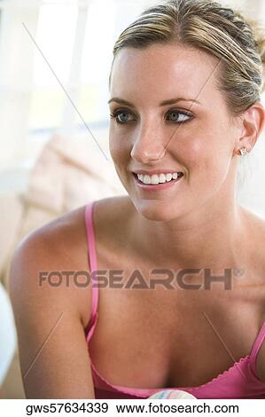 Close-up of a young woman smiling View Large Photo Image Stock Photo - Close-up of a young woman smiling. Fotosearch