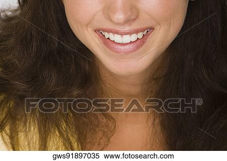 Close-up of a young woman smiling View Large Photo Image Stock Photography - Close-up of a young woman smiling. Fotosearch