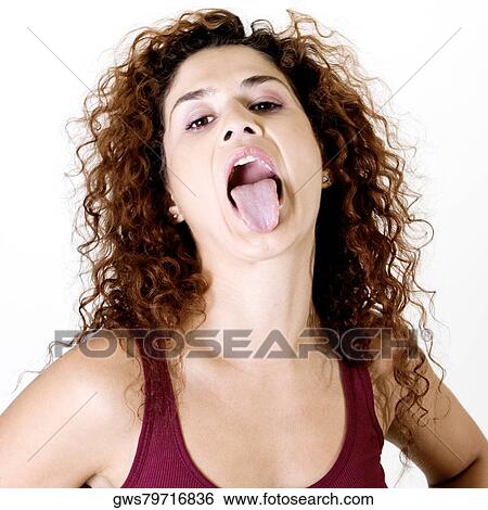 Stock Photograph - Close-up of a young woman sticking out her tongue. Fotosearch