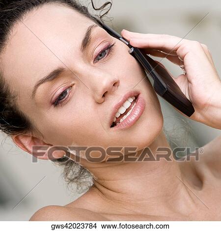Picture - Close-up of a young woman talking on a mobile phone. Fotosearch