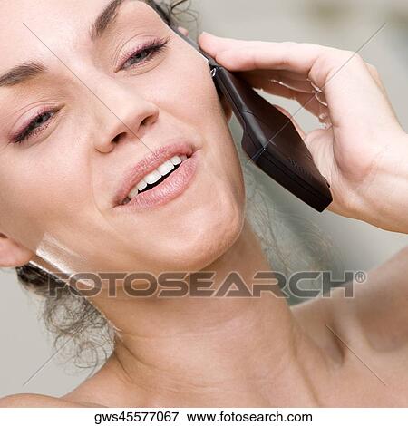 Stock Photo - Close-up of a young woman talking on a mobile phone. Fotosearch
