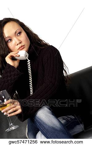 Close-up of a young woman talking on the telephone holding a glass of wine View Large Photo Image Stock Photograph - Close-up of a young woman talking on the telephone holding a glass of wine. Fotosearch