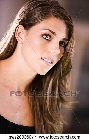 Close-up of a young woman thinking View Large Photo Image Stock Photo - Close-up of a young woman thinking. Fotosearch