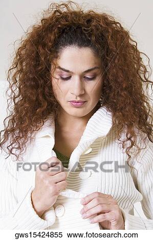 Close-up of a young woman unbuttoning her coat View Large Photo Image Stock Photography - Close-up of a young woman unbuttoning her coat. Fotosearch