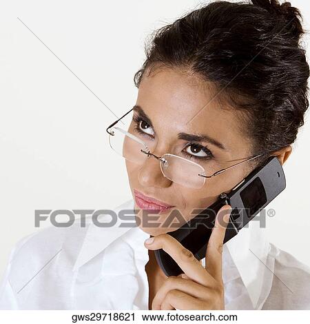 Close-up of a young woman using a mobile phone View Large Photo Image Stock Image - Close-up of a young woman using a mobile phone. Fotosearch