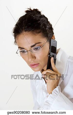 Close-up of a young woman using a mobile phone View Large Photo Image Stock Image - Close-up of a young woman using a mobile phone. Fotosearch