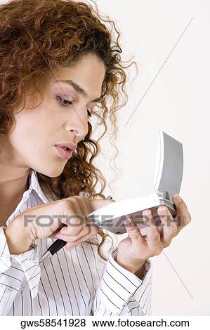 Close-up of a young woman using a calculator View Large Photo Image Stock Photo - Close-up of a young woman using a calculator. Fotosearch