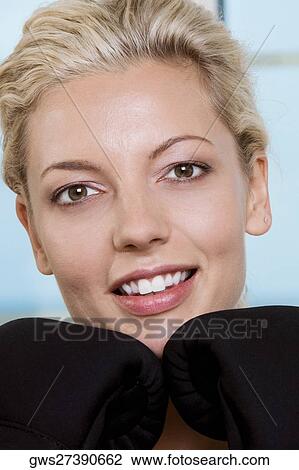 Close-up of a young woman wearing boxing gloves View Large Photo Image Stock Image - Close-up of a young woman wearing boxing gloves. Fotosearch