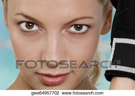 Close-up of a young woman wearing boxing gloves View Large Photo Image Stock Image - Close-up of a young woman wearing boxing gloves. Fotosearch