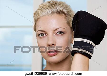 Close-up of a young woman wearing boxing gloves View Large Photo Image Stock Photo - Close-up of a young woman wearing boxing gloves. Fotosearch