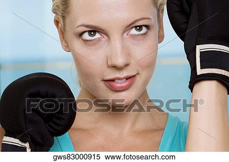 Close-up of a young woman wearing boxing gloves View Large Photo Image Stock Photography - Close-up of a young woman wearing boxing gloves. Fotosearch