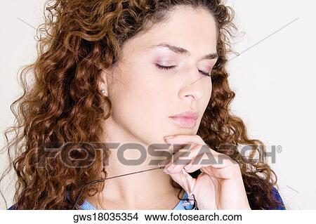 Close-up of a young woman with her eyes closed View Large Photo Image Picture - Close-up of a young woman with her eyes closed. Fotosearch