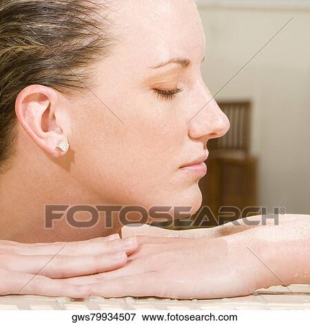 Close-up of a young woman with her eyes closed View Large Photo Image Stock Photo - Close-up of a young woman with her eyes closed. Fotosearch