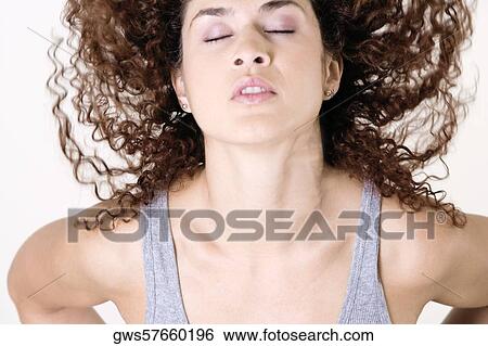 Stock Photograph - Close-up of a young woman with her eyes closed. Fotosearch