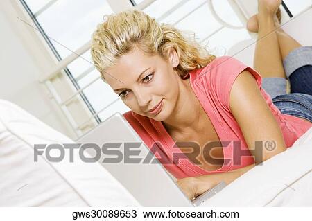 Stock Image - Close-up of a young woman working on a laptop. Fotosearch