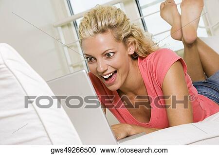 Stock Image - Close-up of a young woman working on a laptop. Fotosearch
