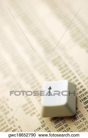 Close-up of an arrow key on a financial newspaper View Large Photo Image Stock Image - Close-up of an arrow key on a financial newspaper. Fotosearch