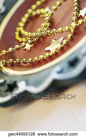 Close-up of golden beads on a tray View Large Photo Image Stock Photo - Close-up of golden beads on a tray. Fotosearch