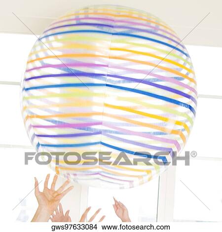Picture - Close-up of human hands playing with a ball. Fotosearch
