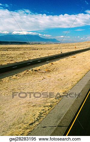 Stock Photography - Empty road under a cloudy sky. Fotosearch