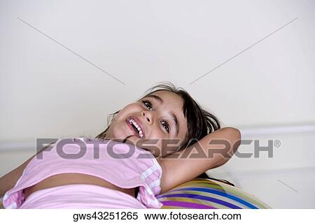 Girl lying on an inflatable ball View Large Photo Image Stock Photography - Girl lying on an inflatable ball. Fotosearch