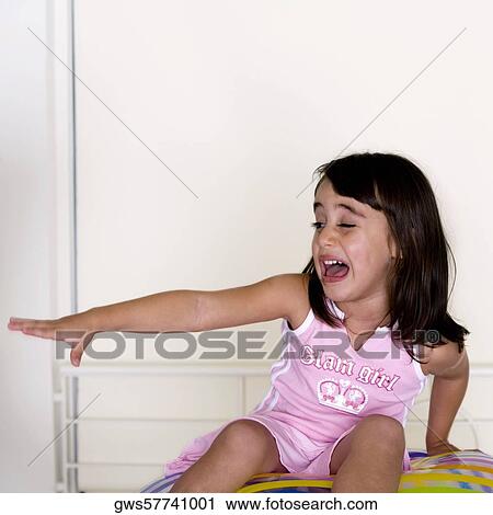 Girl sitting on an inflatable ball crying View Large Photo Image Stock Image - Girl sitting on an inflatable ball crying. Fotosearch
