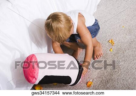 High angle view of a boy playing with a cushion View Large Photo Image Picture - High angle view of a boy playing with a cushion. Fotosearch