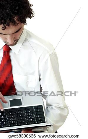 High angle view of a businessman using a laptop View Large Photo Image Stock Photograph - High angle view of a businessman using a laptop. Fotosearch