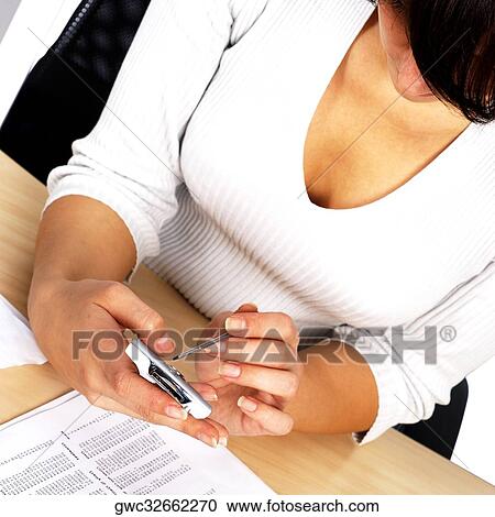Stock Image - High angle view of a businesswoman using a personal data assistant. Fotosearch