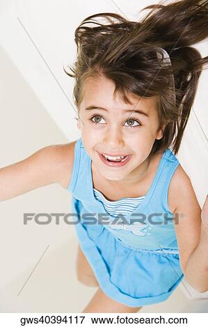 Stock Photo - High angle view of a girl lying down. Fotosearch