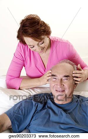 High angle view of a senior woman giving a senior man a head massage View Large Photo Image Stock Image - High angle view of a senior woman giving a senior man a head massage. Fotosearch