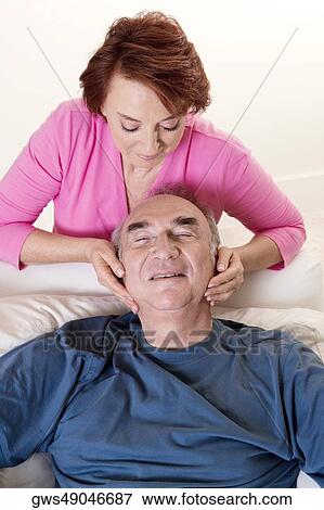 High angle view of a senior woman giving a senior man a head massage View Large Photo Image Stock Photo - High angle view of a senior woman giving a senior man a head massage. Fotosearch