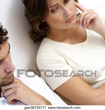 High angle view of a young couple looking serious View Large Photo Image Stock Image - High angle view of a young couple looking serious. Fotosearch
