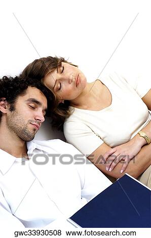 High angle view of a young couple sleeping against a wall View Large Photo Image Stock Photo - High angle view of a young couple sleeping against a wall. Fotosearch