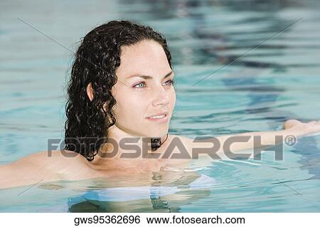 High angle view of a young woman in a swimming pool View Large Photo Image Stock Photograph - High angle view of a young woman in a swimming pool. Fotosearch