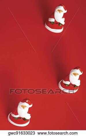 Stock Image - High angle view of Santa Claus figurines. Fotosearch