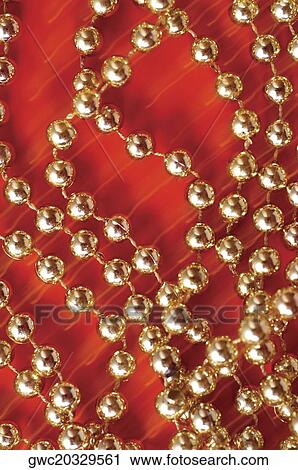 High angle view of strings of golden beads View Large Photo Image Stock Image - High angle view of strings of golden beads. Fotosearch