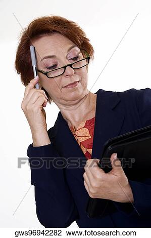 Stock Image - Low angle view of a businesswoman holding a file and a pen. Fotosearch