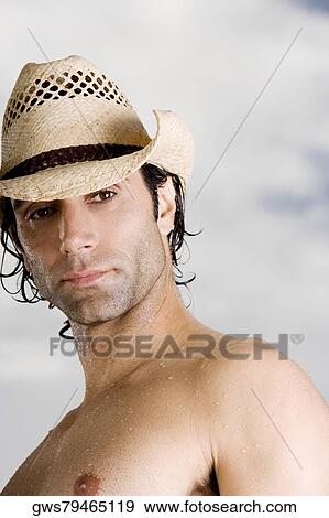 Low angle view of a mid adult man wearing a hat View Large Photo Image Stock Photo - Low angle view of a mid adult man wearing a hat. Fotosearch