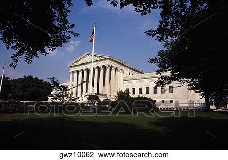 Low angle view of an American flag in front of a government building, US Supreme Court, Washington DC, USA View Large Photo Image Stock Image - Low angle view of an American flag in front of a government building, US Supreme Court, Washington DC, USA. Fotosearch